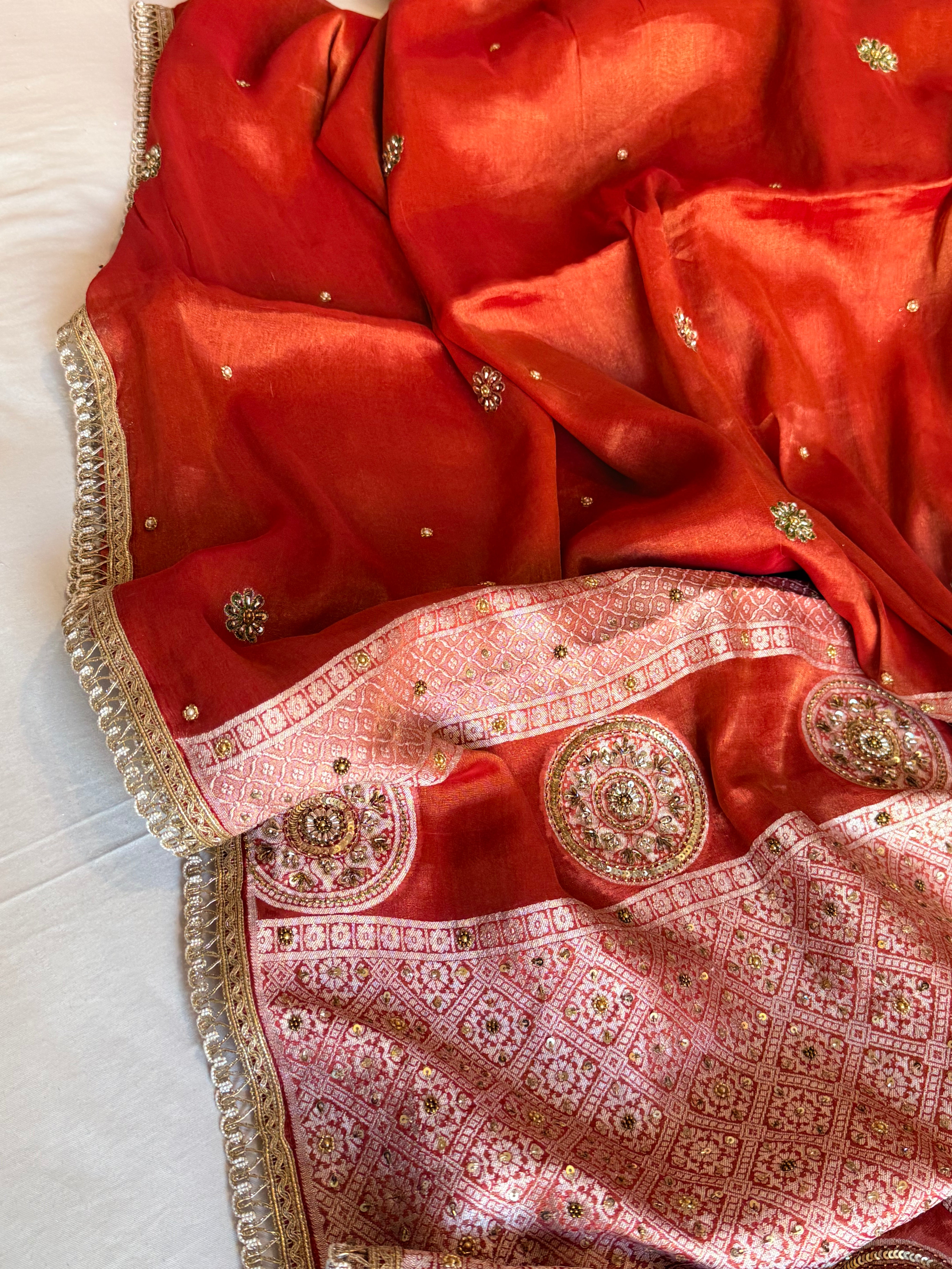 Reddish-orange tissue gorgette hand embroidered kadhwa brocade pallu saree