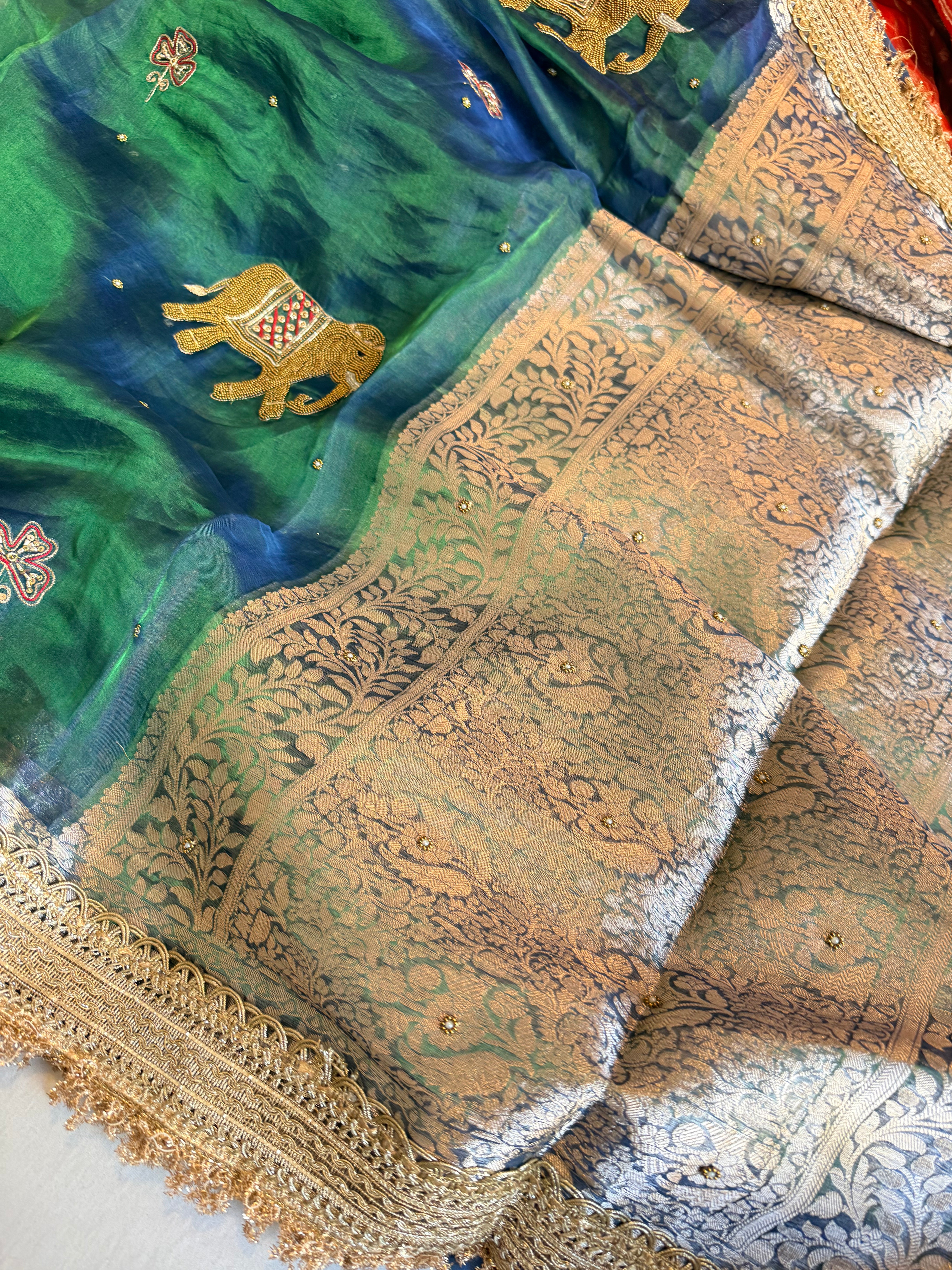 Elephant motif peacock blue dhup chao effect tissue silk hand embroidered saree