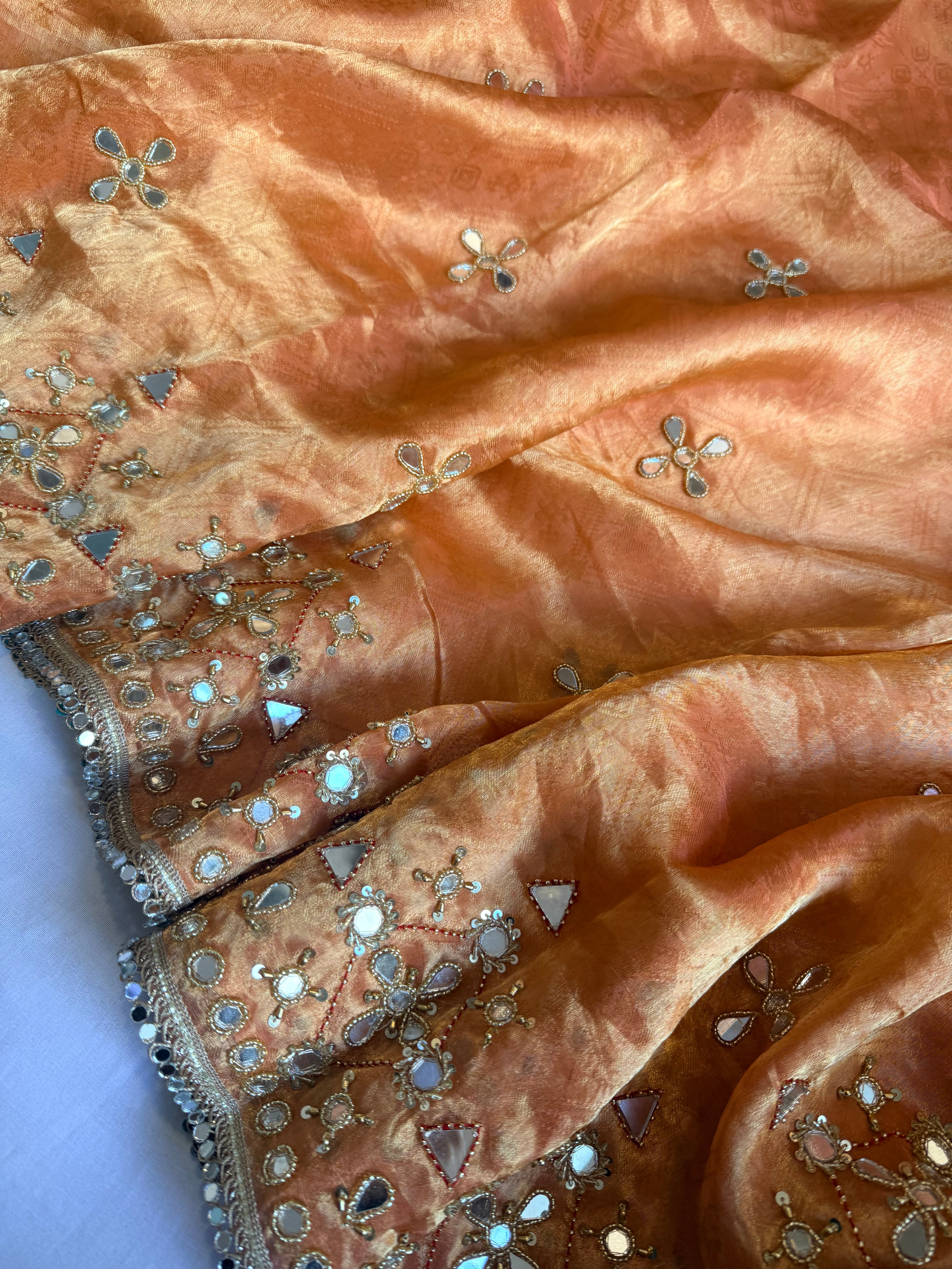 Dhup chao effect kesari orange tanchui tissue silk mirrorwork hand embroidered kadhwa saree