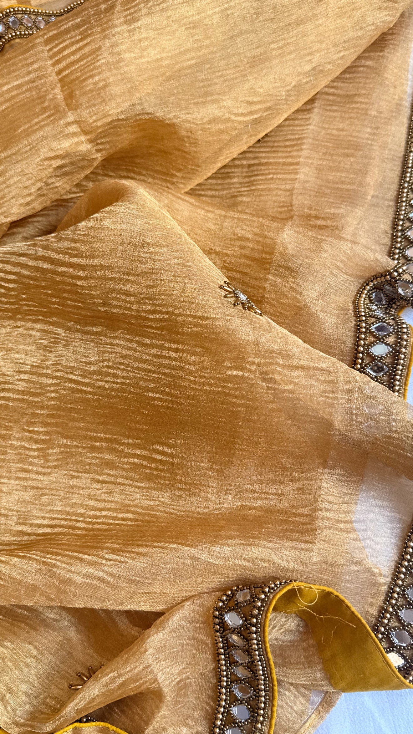 Mirrorwork edit light orange crushed tissue silk hand embroidered saree