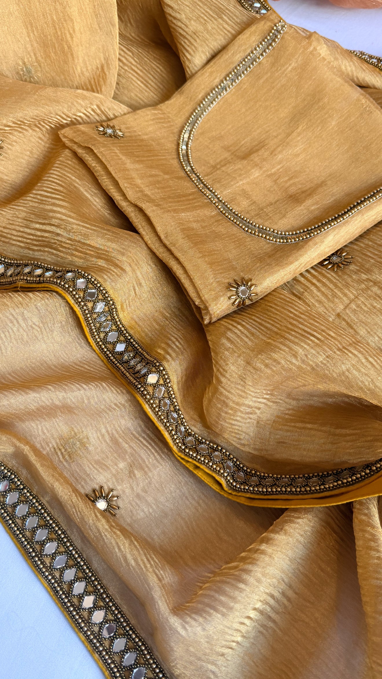 Mirrorwork edit light orange crushed tissue silk hand embroidered saree