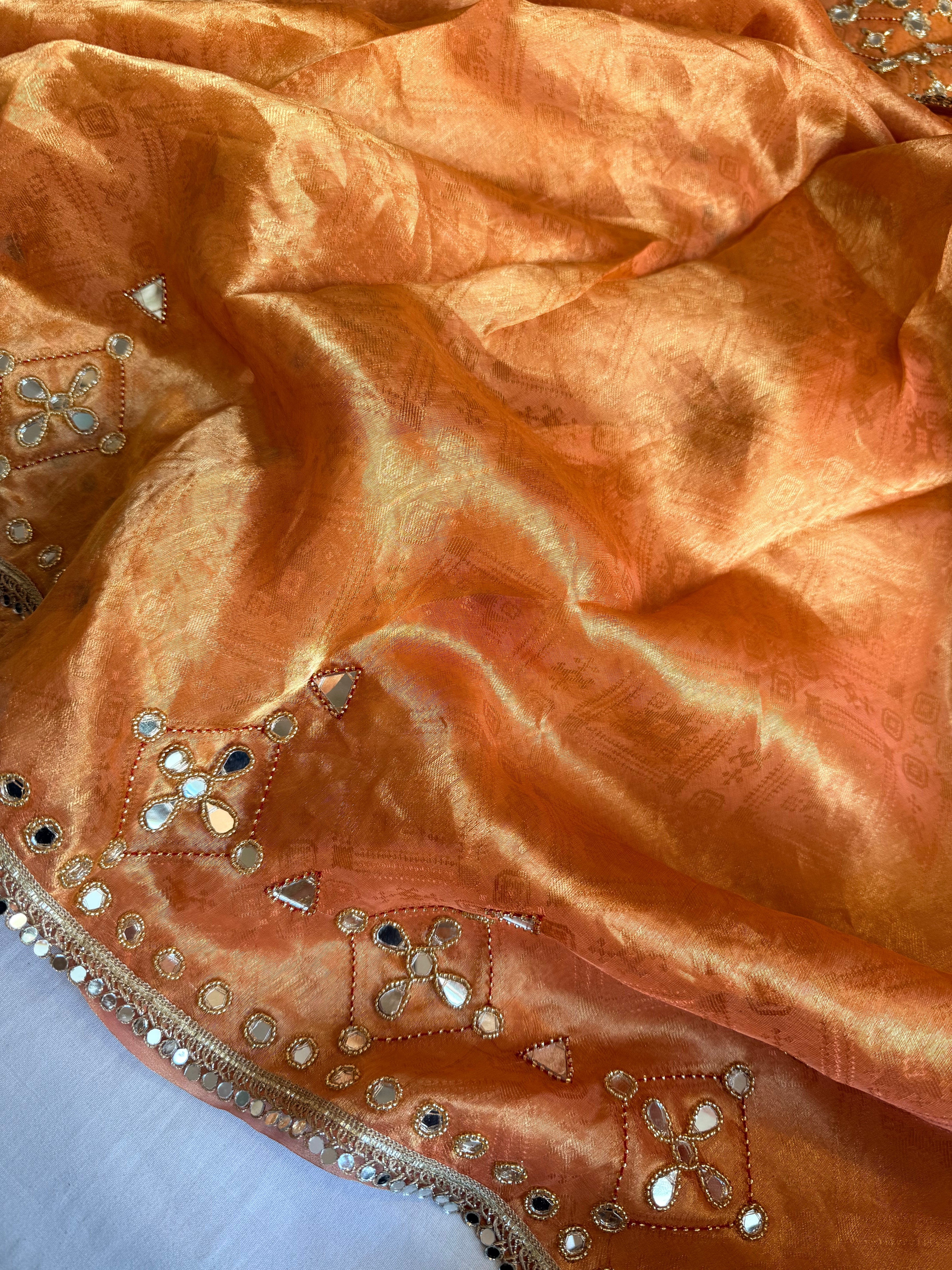 Dhup chao effect kesari orange tanchui tissue silk mirrorwork hand embroidered kadhwa saree