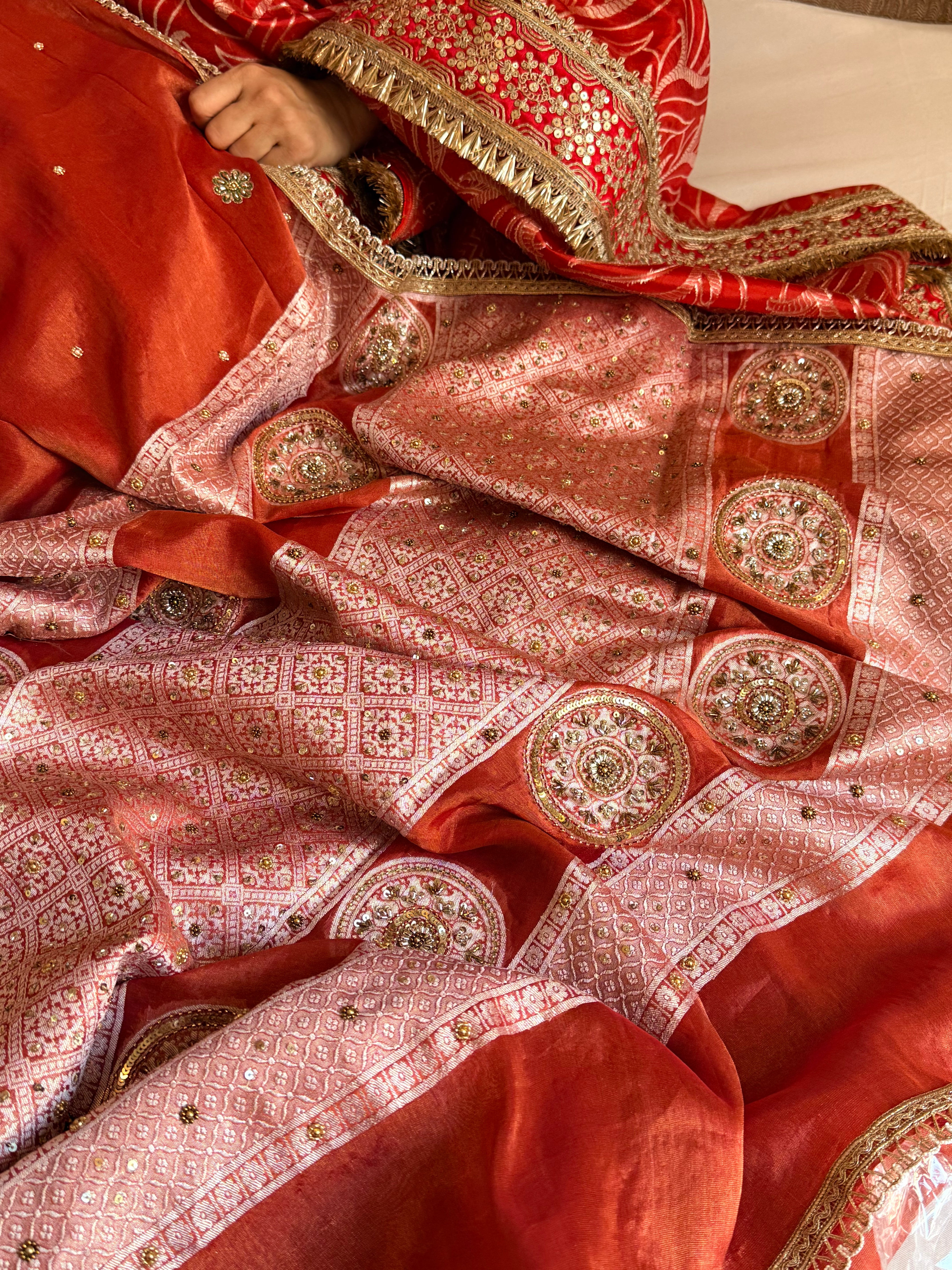 Reddish-orange tissue gorgette hand embroidered kadhwa brocade pallu saree