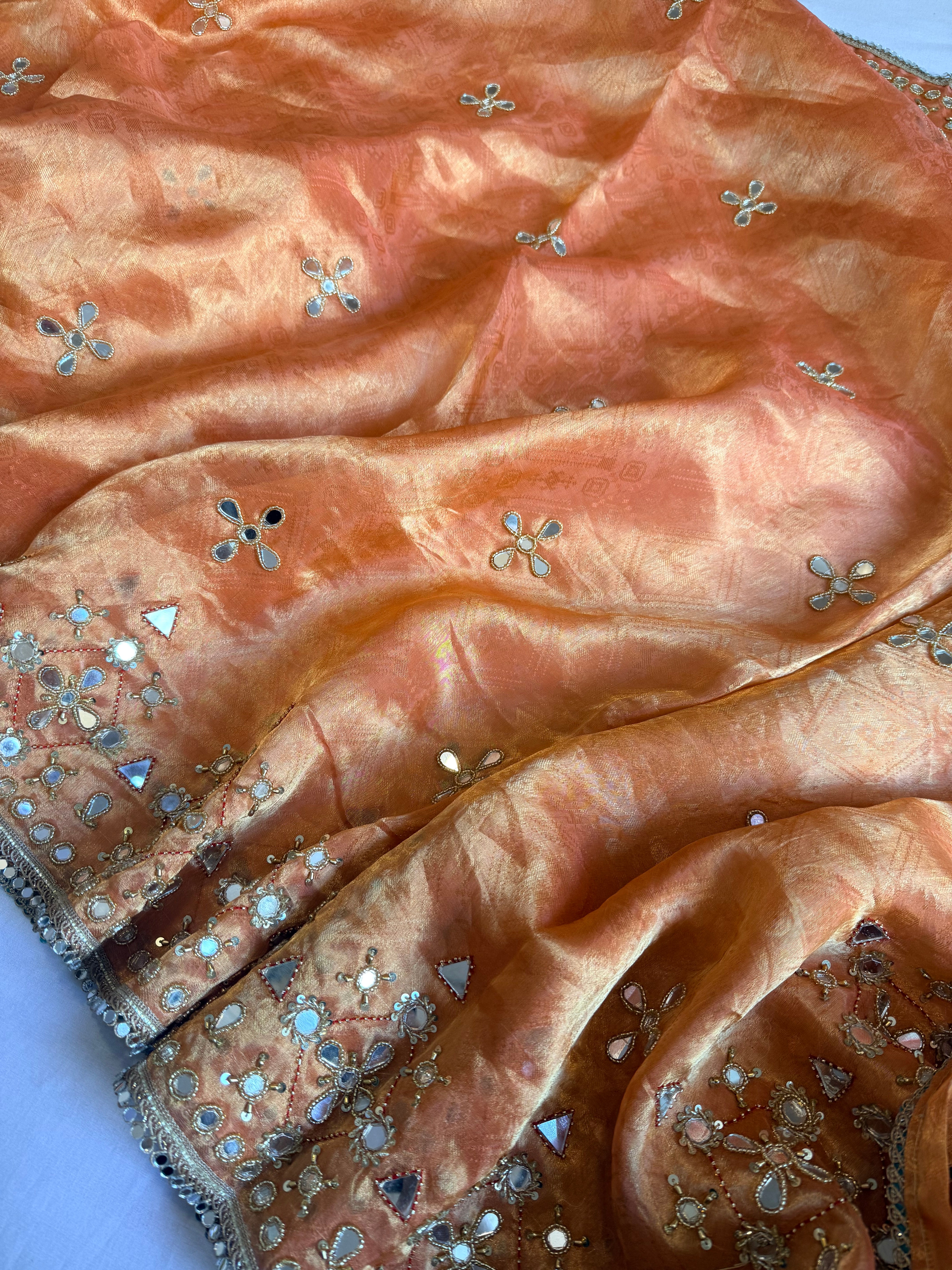 Dhup chao effect kesari orange tanchui tissue silk mirrorwork hand embroidered kadhwa saree