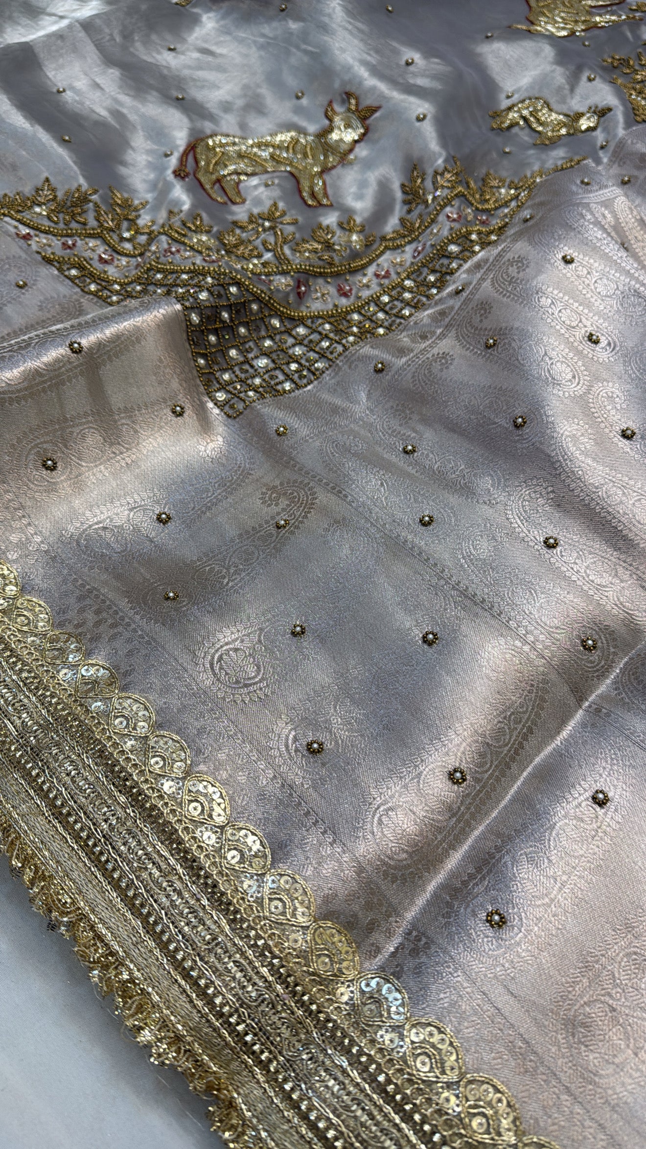 Metallic grey nandi motif hand embroidered tissue silk saree
