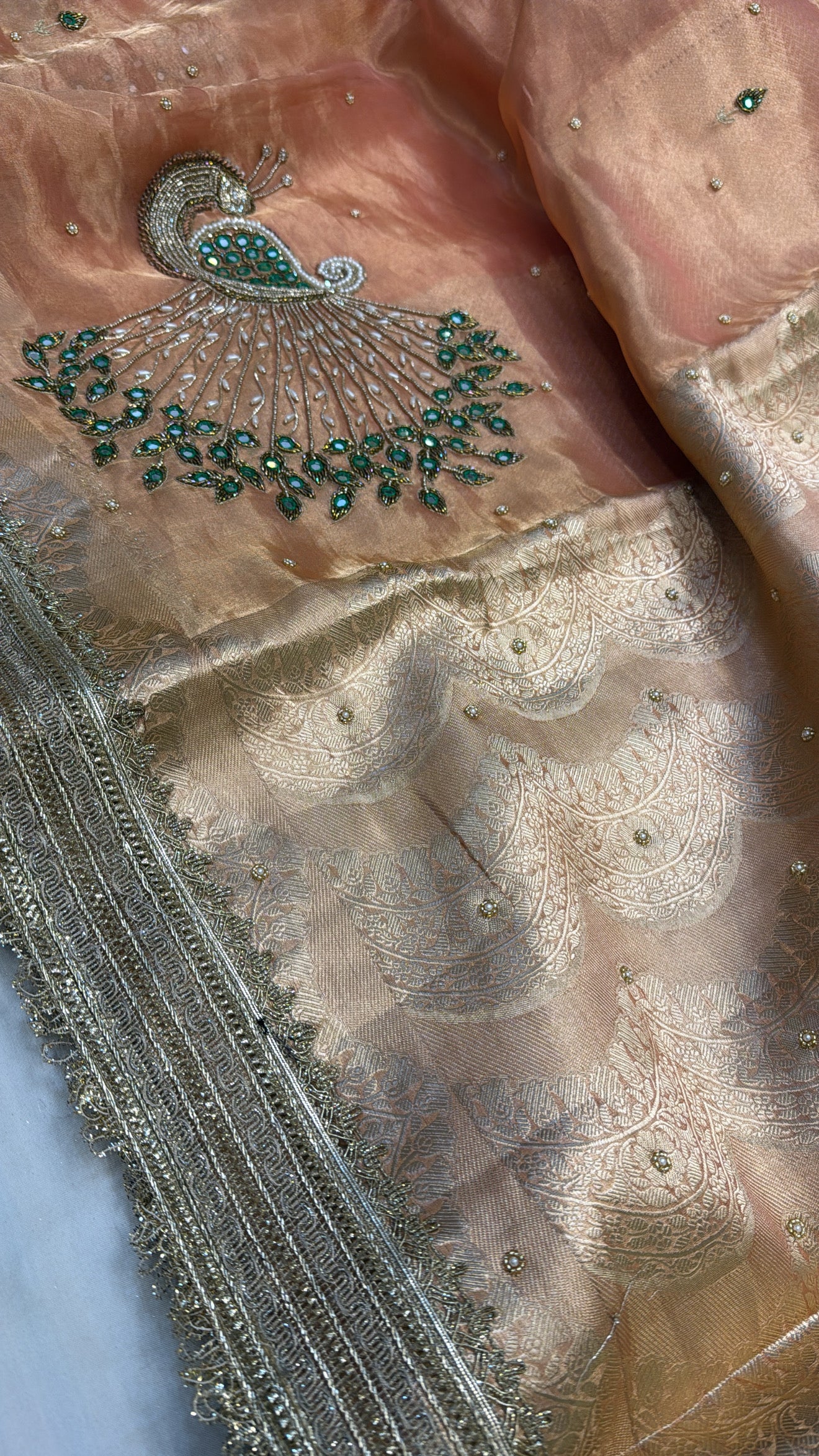 Peachish orange peacock motif hand embroidered kadhwa saree