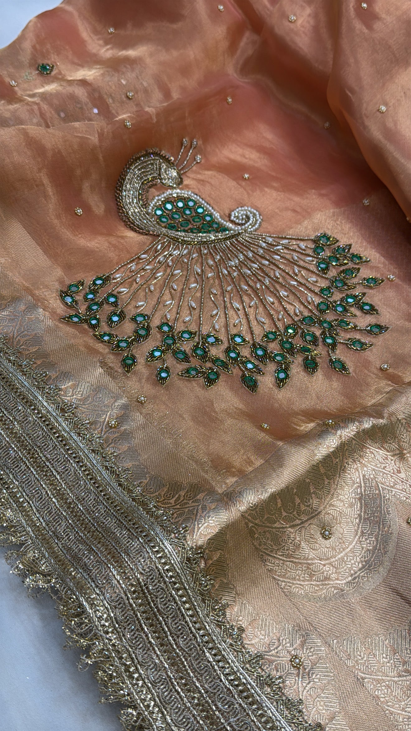 Peachish orange peacock motif hand embroidered kadhwa saree