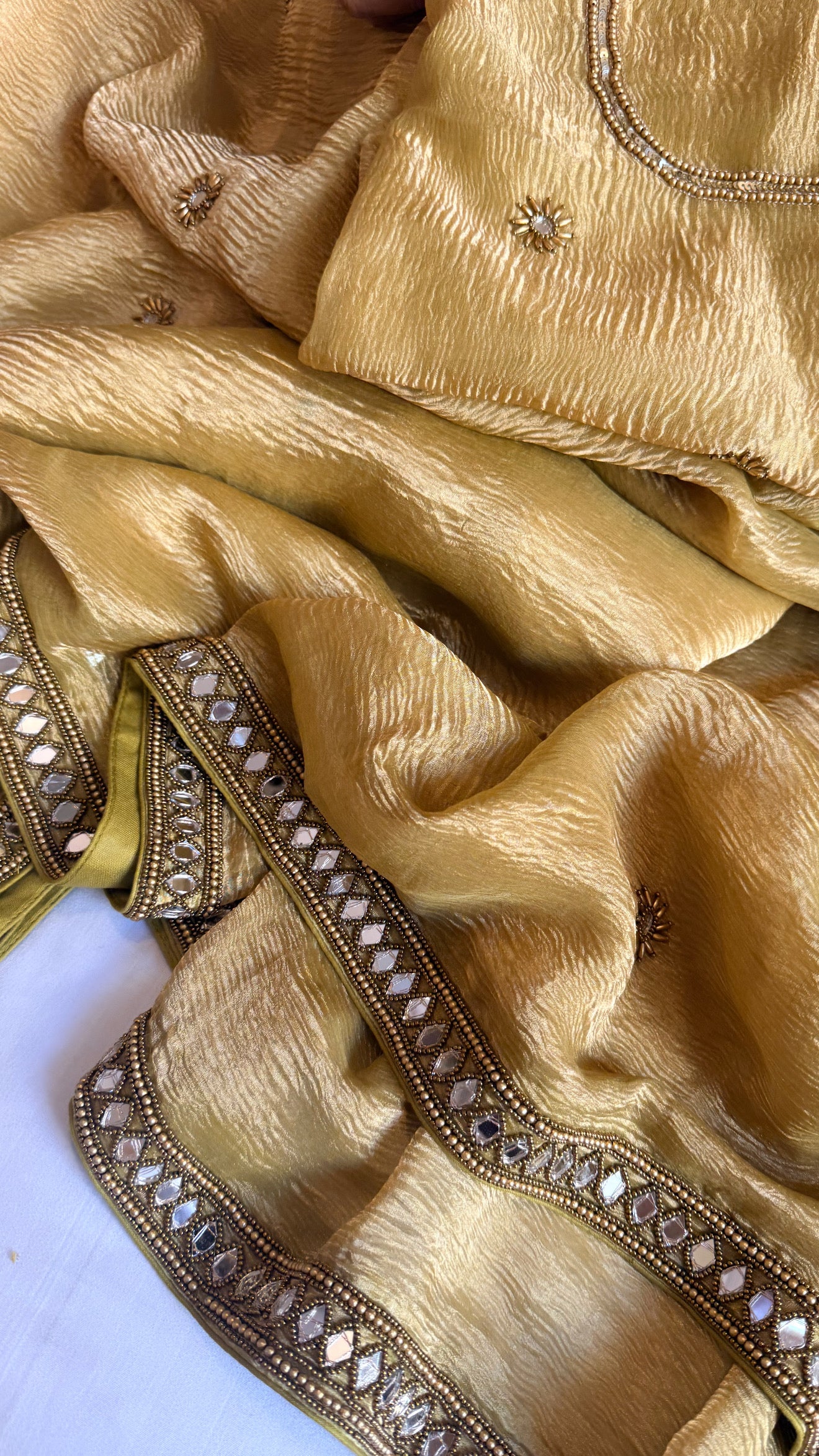 Mirrorwork edit mustard gold crushed tissue silk hand embroidered saree