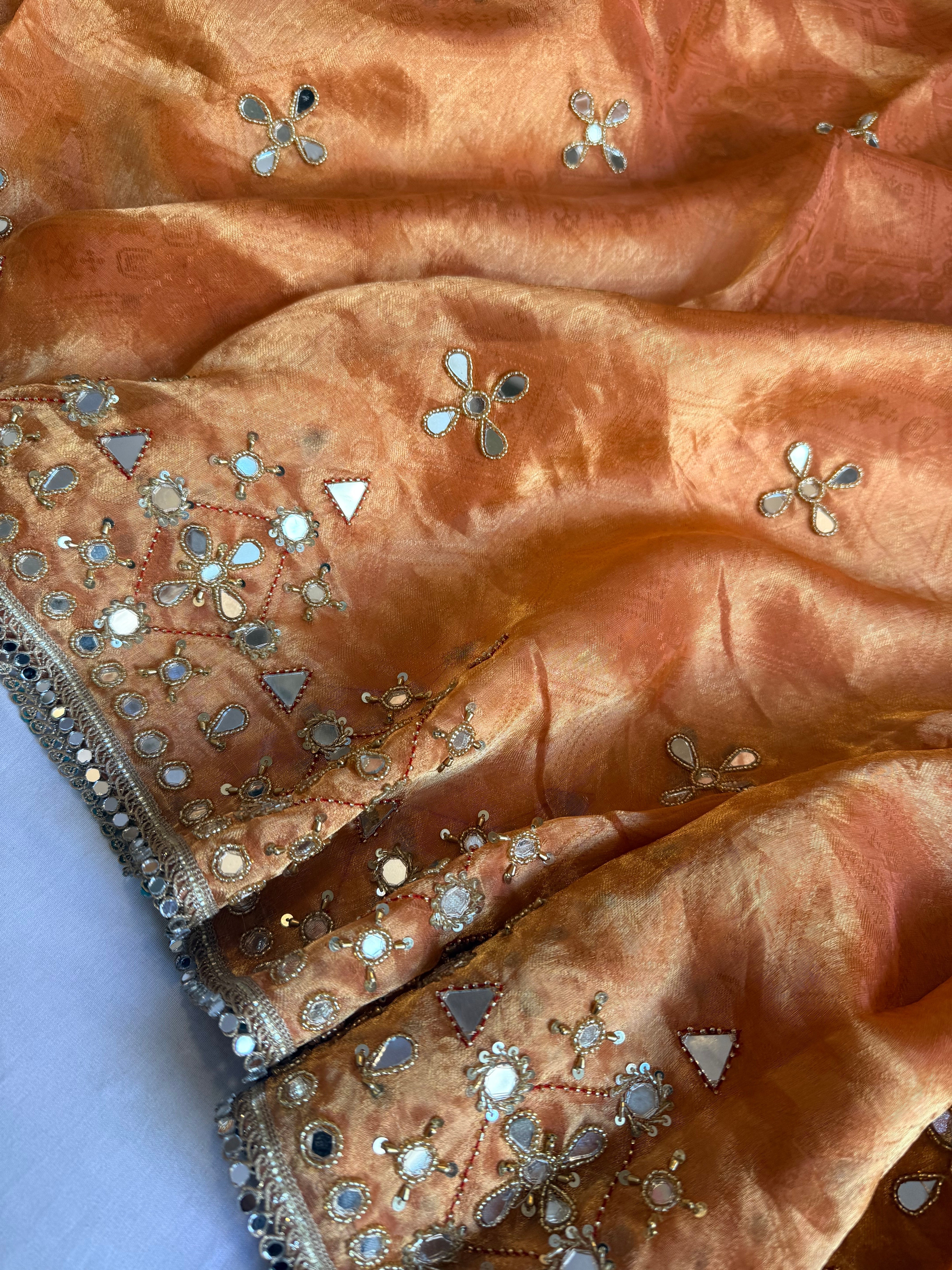 Dhup chao effect kesari orange tanchui tissue silk mirrorwork hand embroidered kadhwa saree