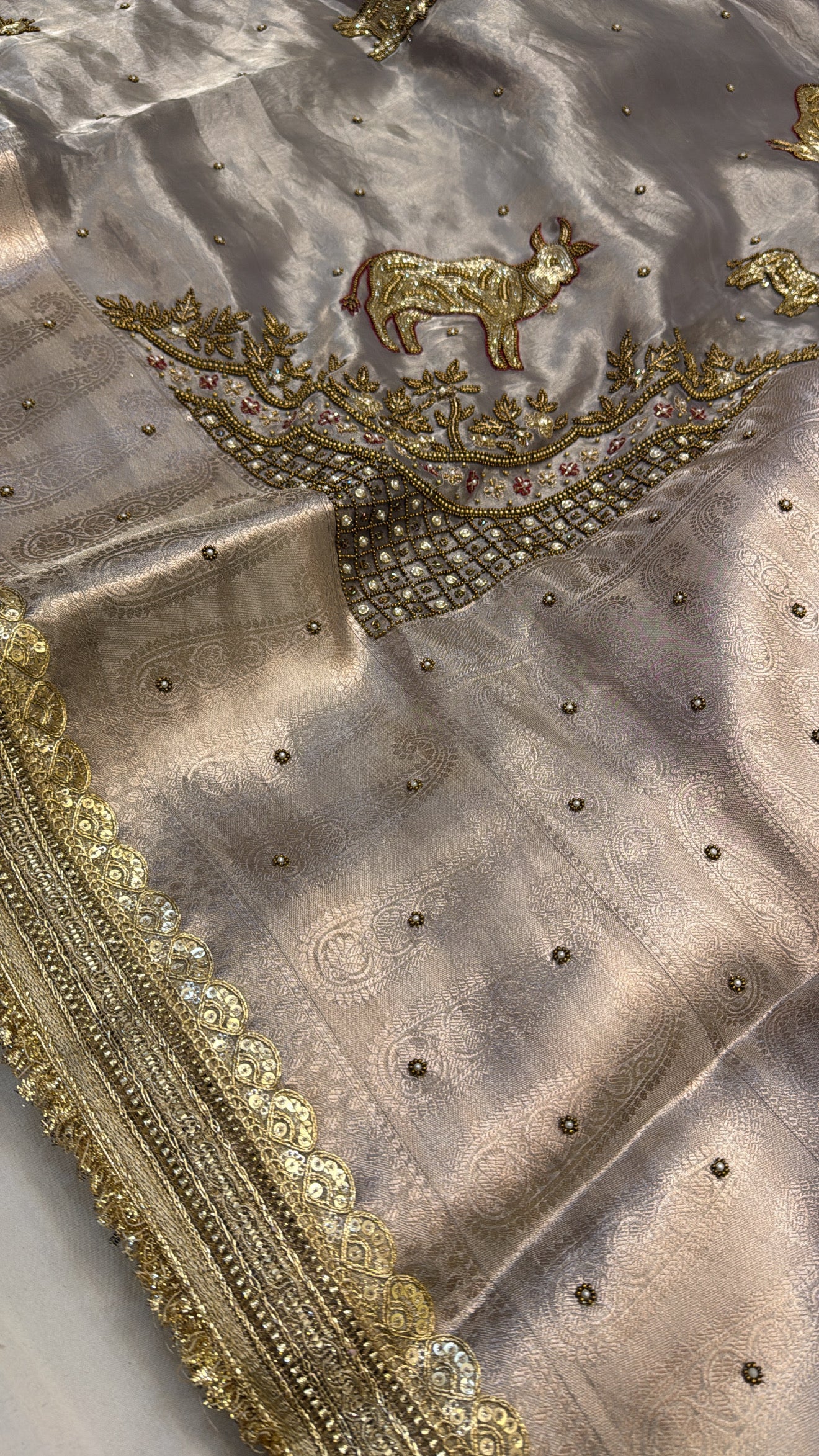 Metallic grey nandi motif hand embroidered tissue silk saree