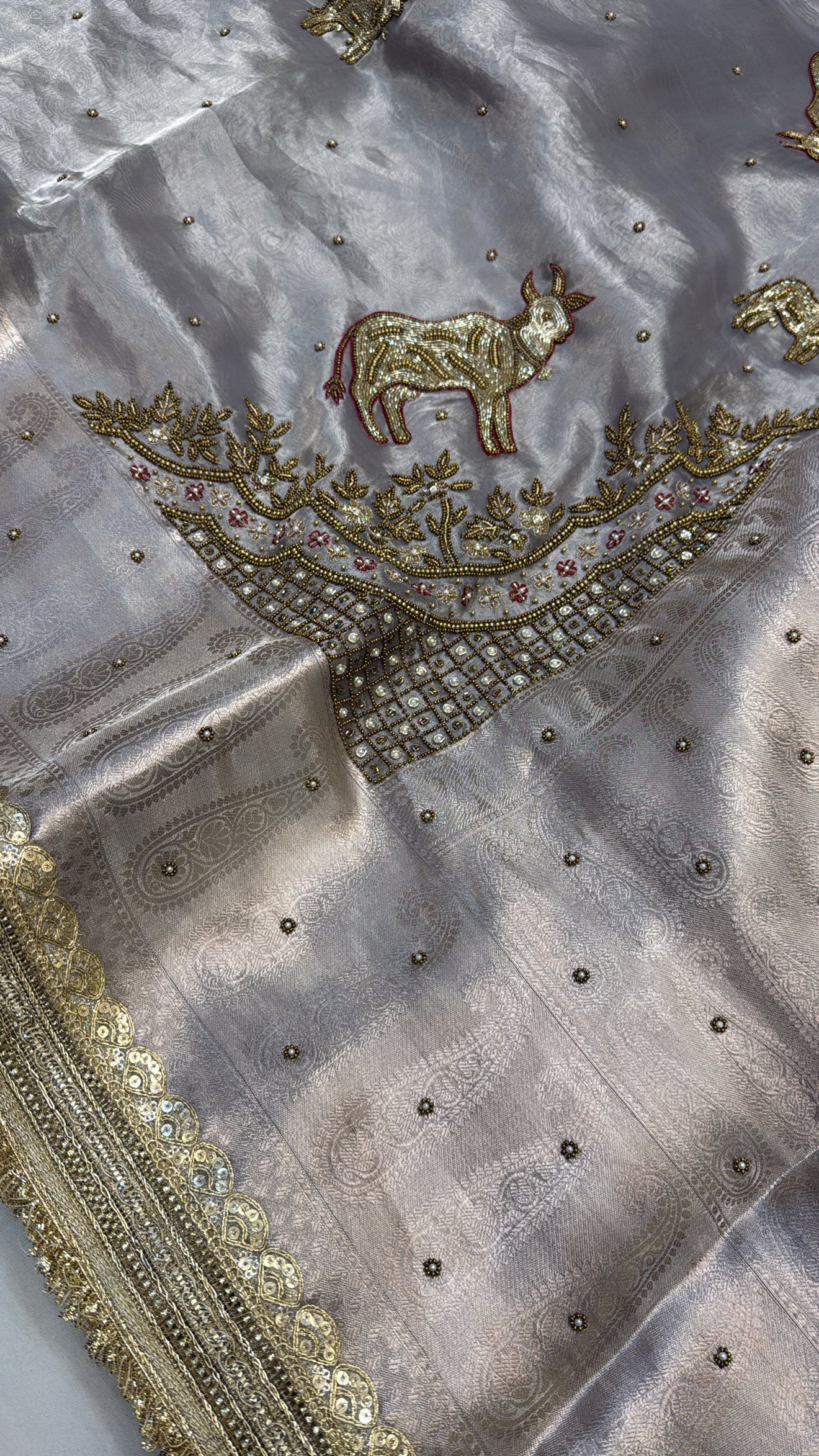 Metallic grey nandi motif hand embroidered tissue silk saree