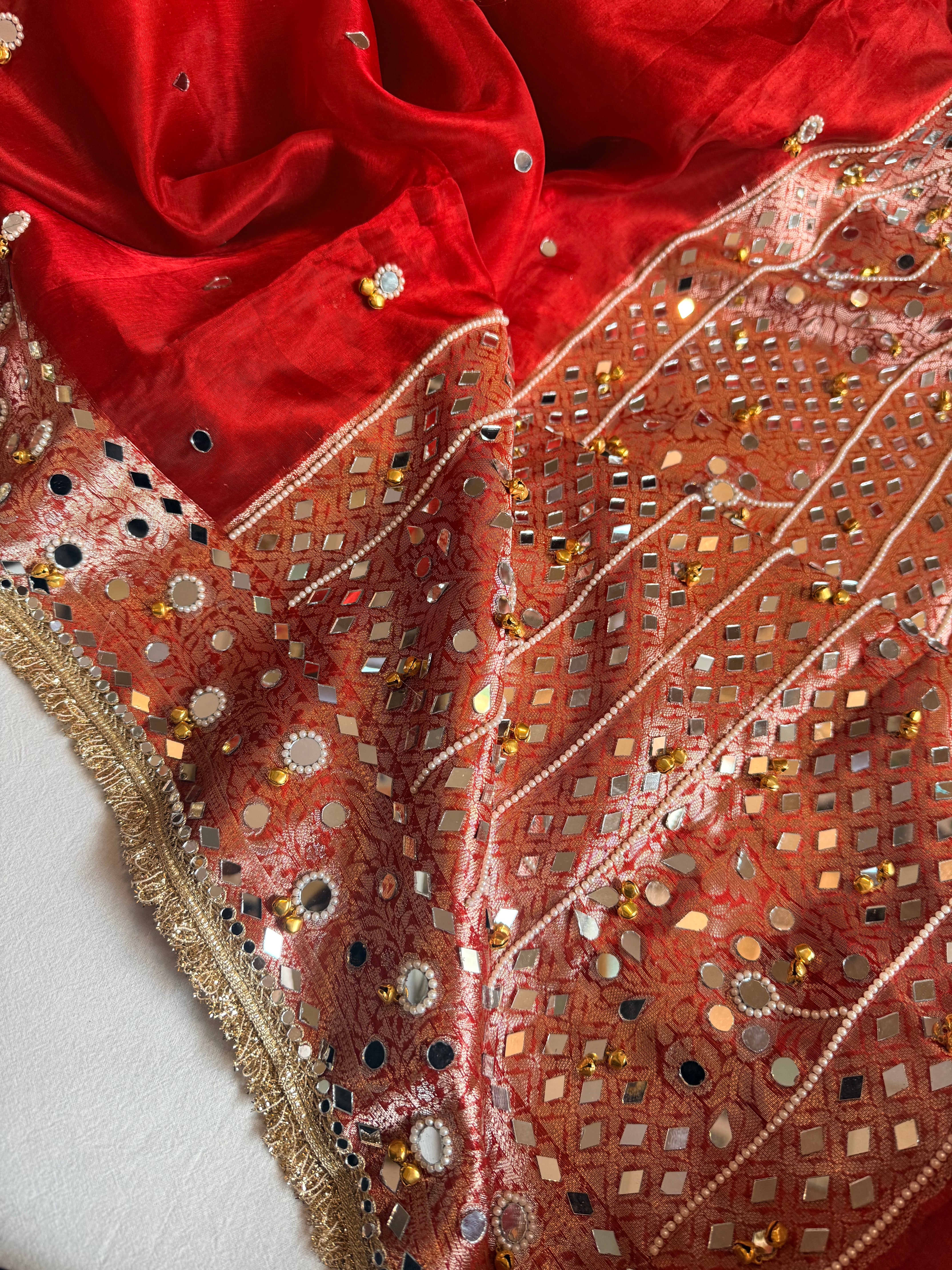 Sindoori red ghungroo and mirrorwork hand embroidered kadhwa saree