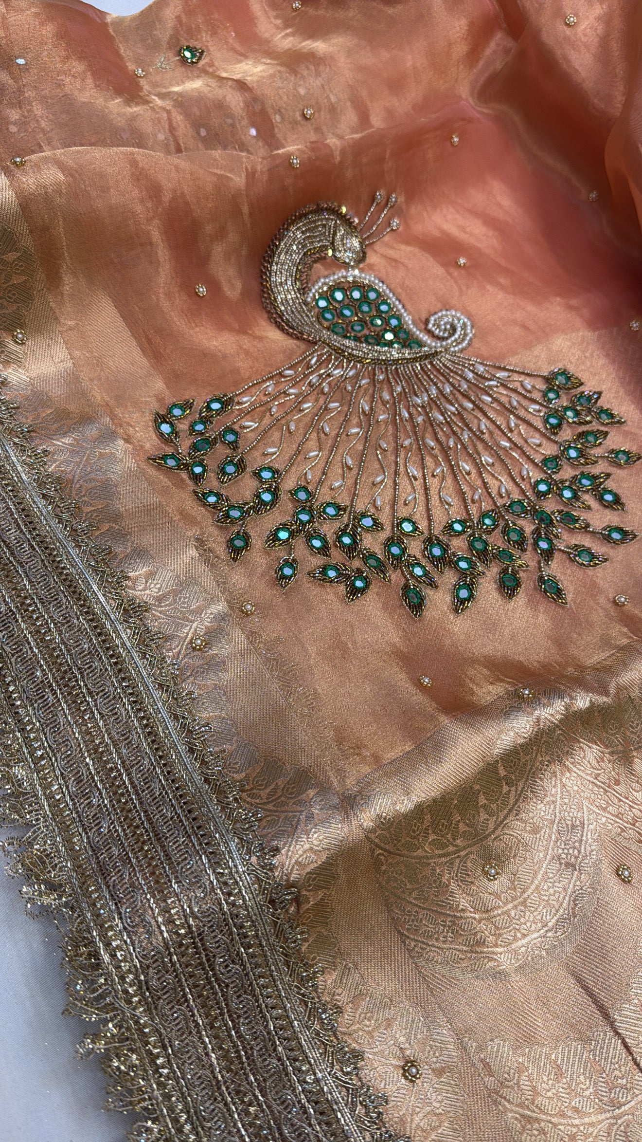 Peachish orange peacock motif hand embroidered kadhwa saree