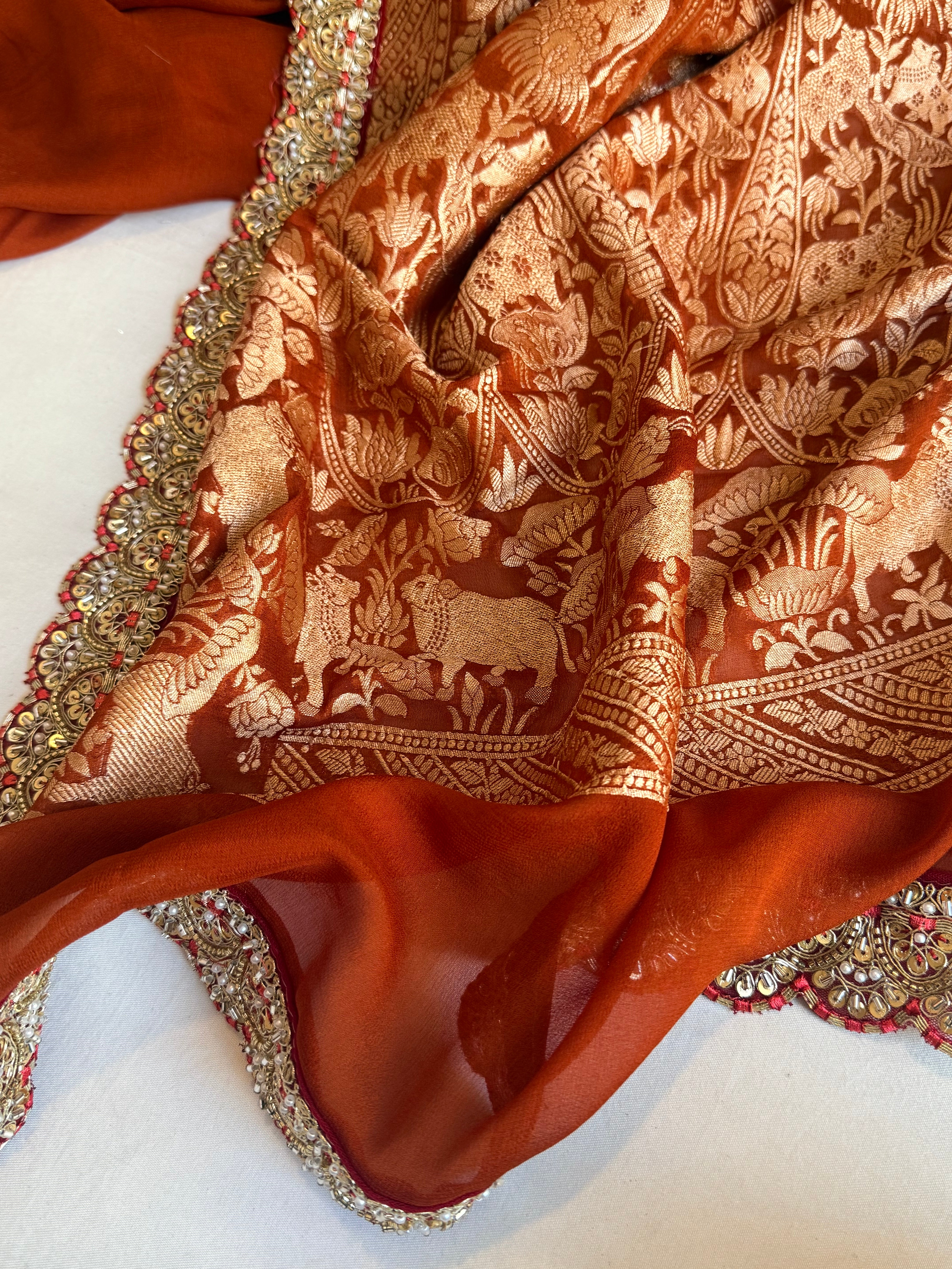 Brick red shikargah kadhwa border chiffon gorgette banarasi saree