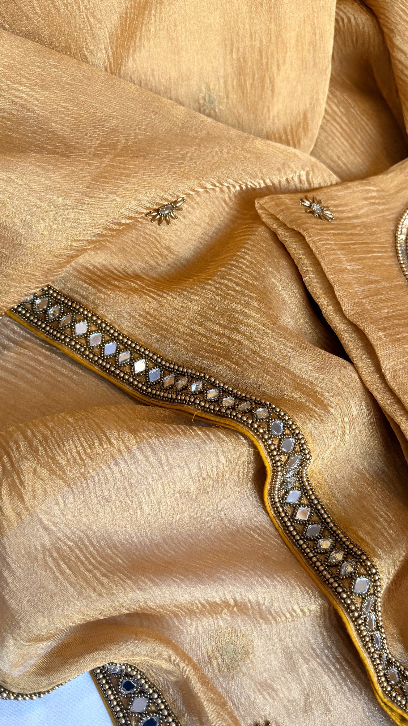 Mirrorwork edit light orange crushed tissue silk hand embroidered saree