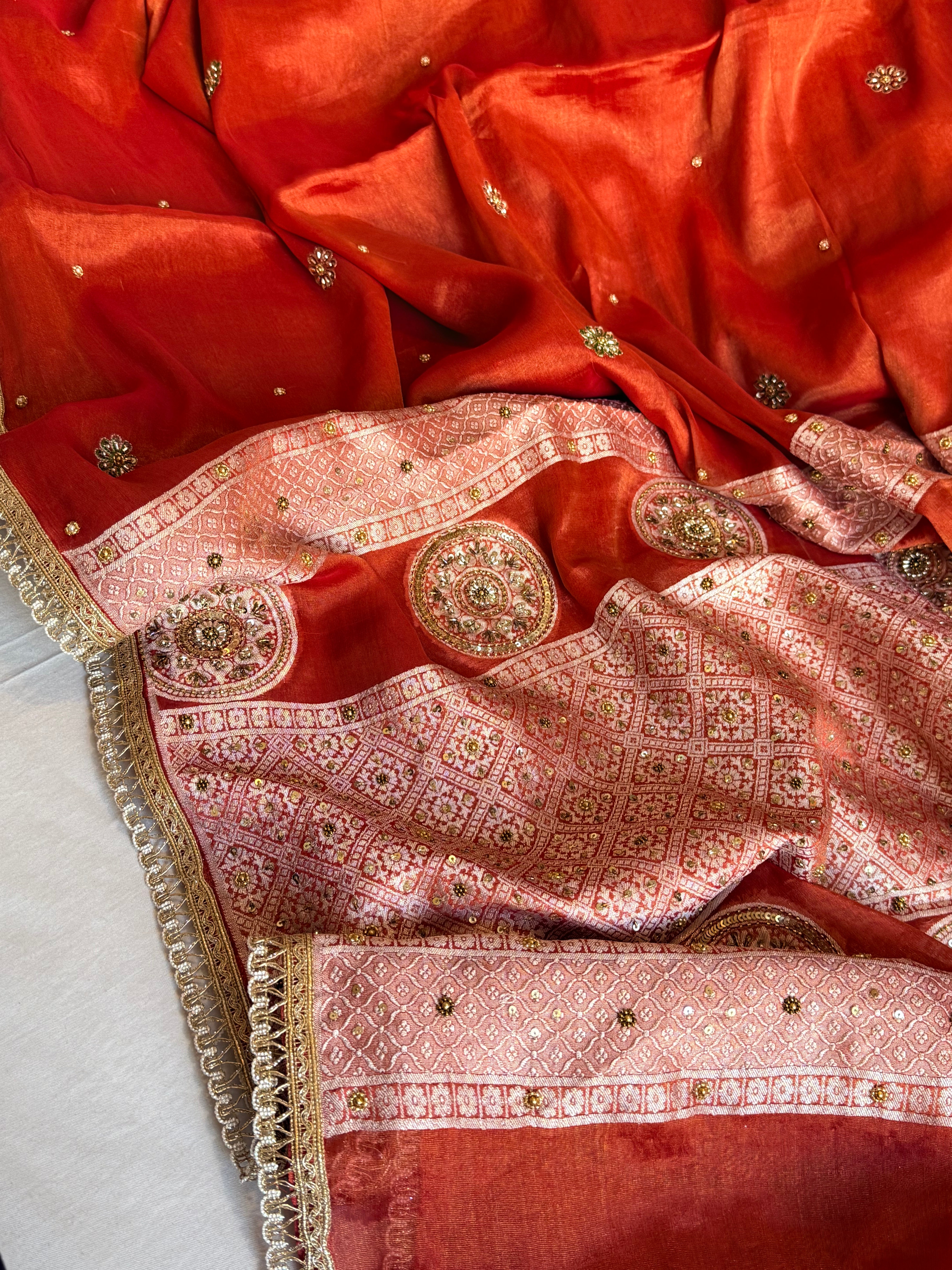 Reddish-orange tissue gorgette hand embroidered kadhwa brocade pallu saree