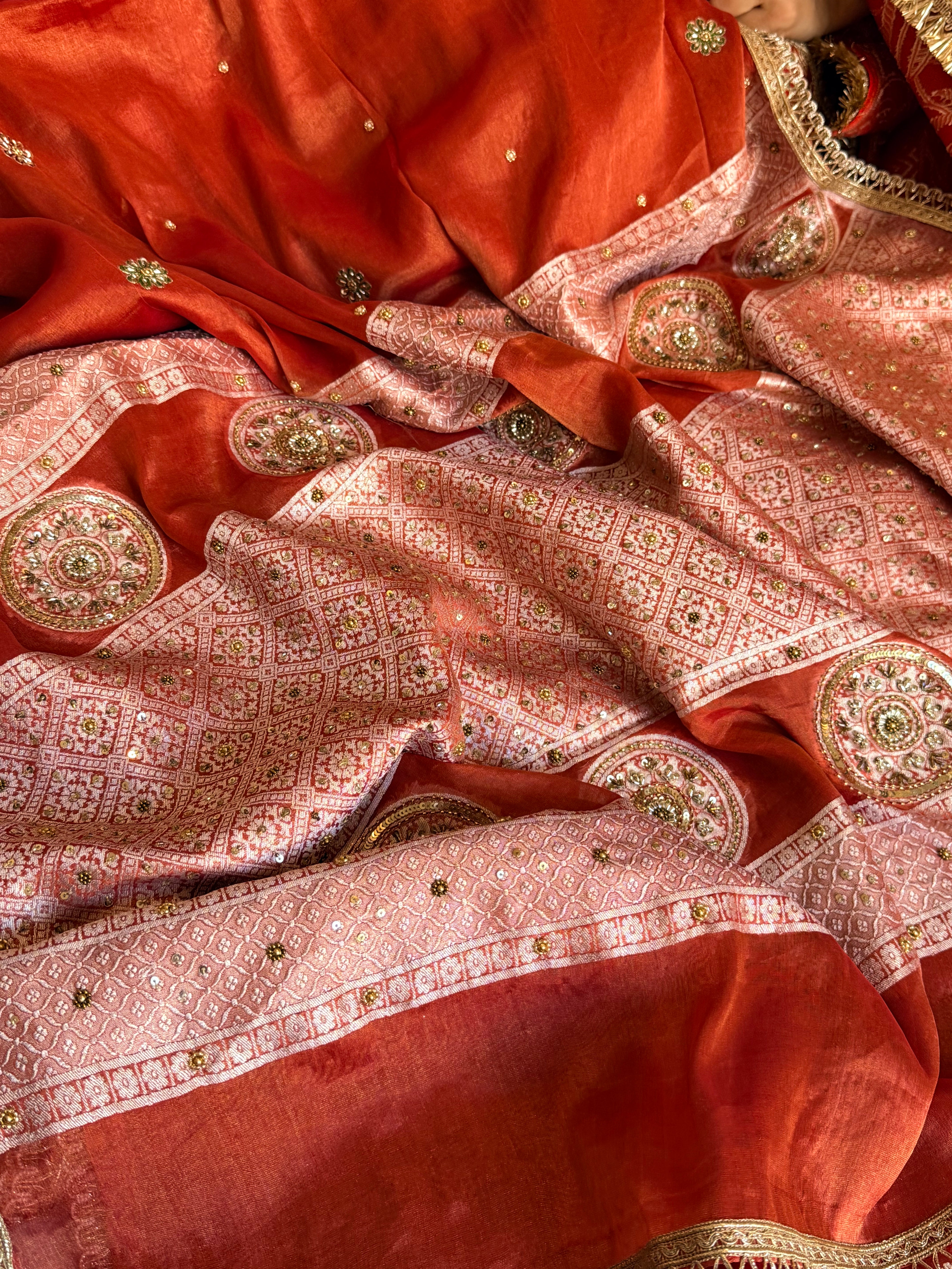 Reddish-orange tissue gorgette hand embroidered kadhwa brocade pallu saree