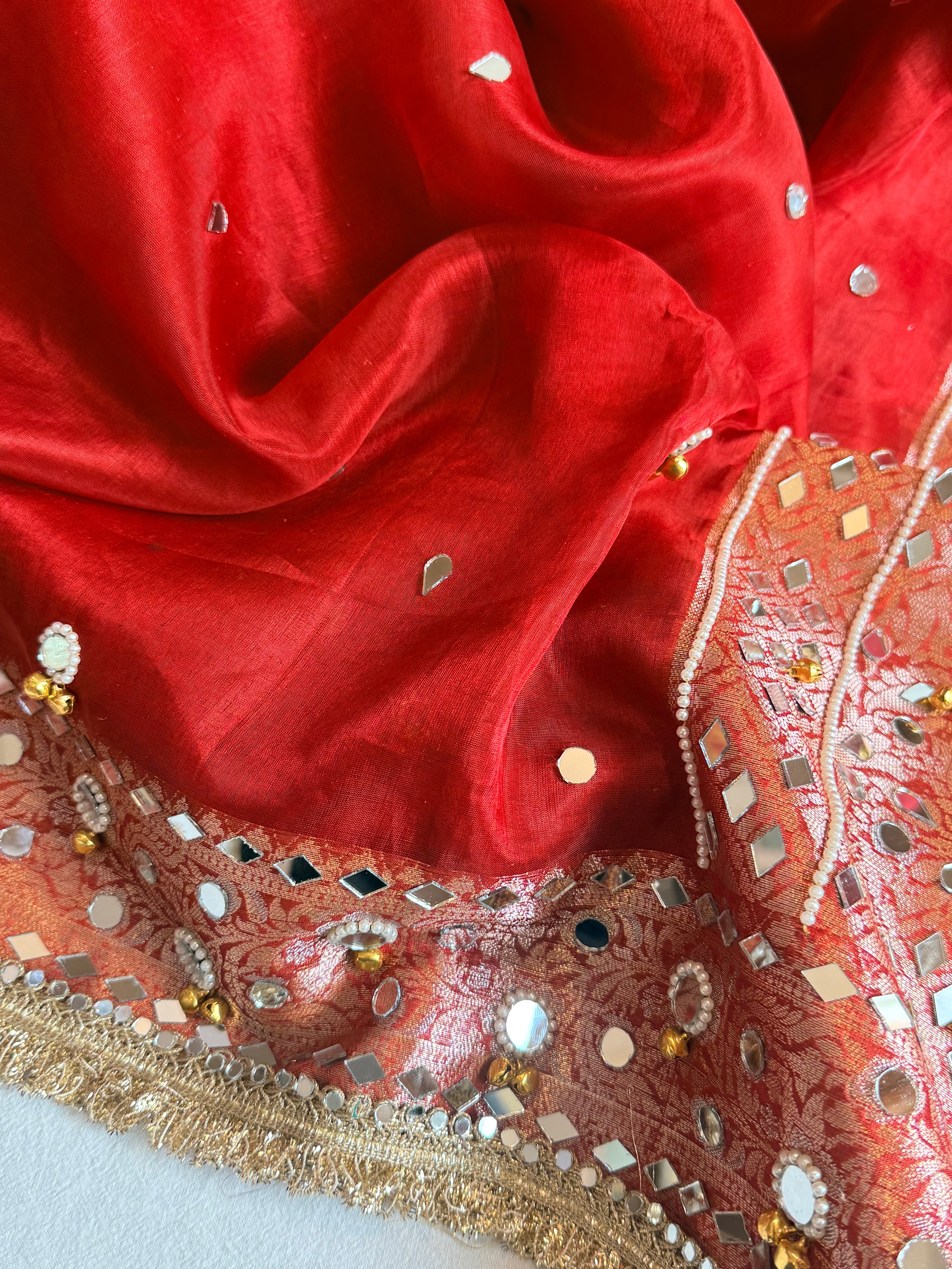 Sindoori red ghungroo and mirrorwork hand embroidered kadhwa saree