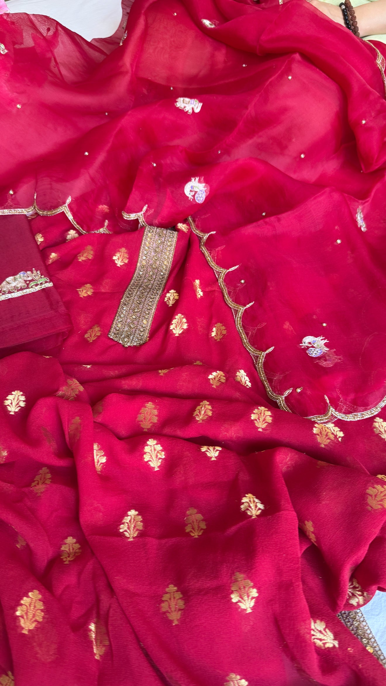 Crimson red banarasi gorgette kadhwa buti kurta paired with toy hathi motif kora silk scalloped duppata set