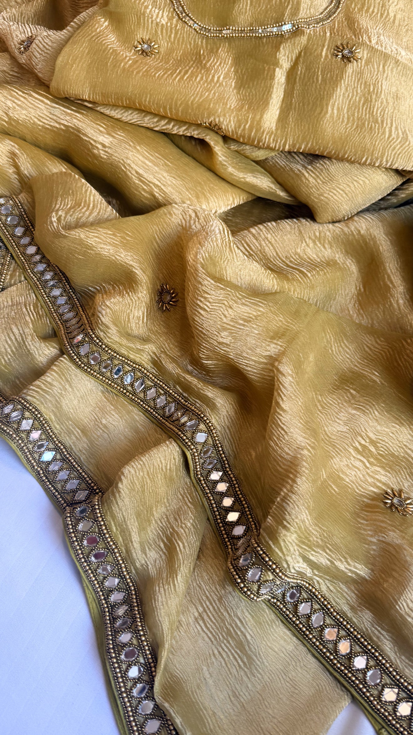 Mirrorwork edit mustard gold crushed tissue silk hand embroidered saree